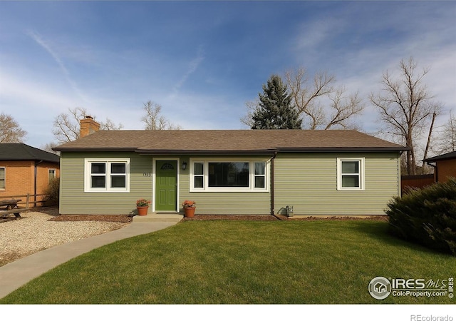 ranch-style house with a chimney and a front yard