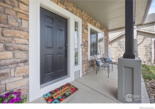 109 Whitney Ct, Windsor, CO 80550 - view of exterior entry with covered porch and stone siding