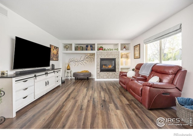 109 Whitney Ct, Windsor, CO 80550 - living area with dark wood finished floors, built in shelves, and a tiled fireplace