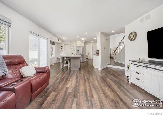 109 Whitney Ct, Windsor, CO 80550 - living area featuring dark wood-style floors, stairway, recessed lighting, and baseboards