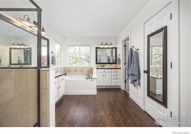 109 Whitney Ct, Windsor, CO 80550 - full bath with wood finished floors, healthy amount of natural light, a garden tub, and two vanities
