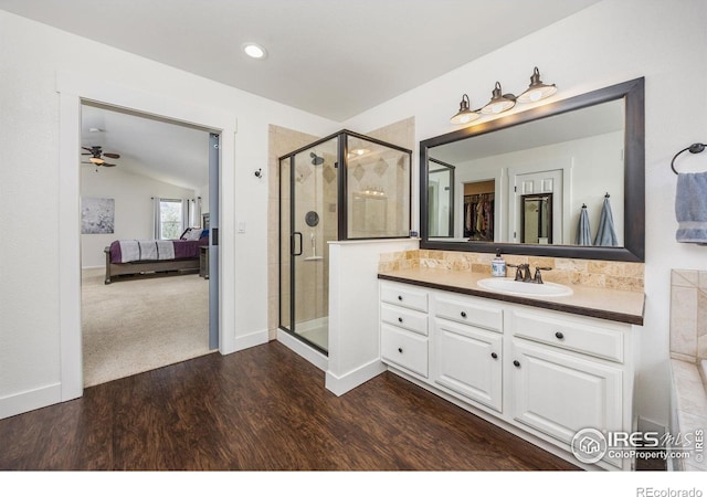 109 Whitney Ct, Windsor, CO 80550 - ensuite bathroom with a shower stall, vanity, ceiling fan, lofted ceiling, and wood finished floors