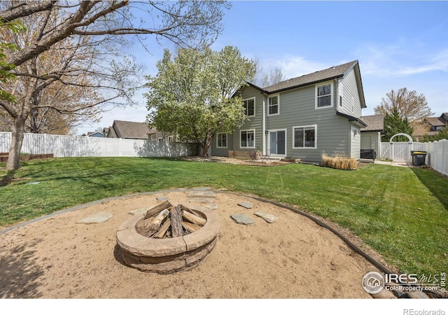 109 Whitney Ct, Windsor, CO 80550 - back of property featuring a fire pit and a gate