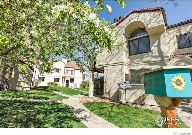 5035 W 73rd Ave, Westminster, CO 80030 - exterior space with a lawn, stucco siding, and a tile roof
