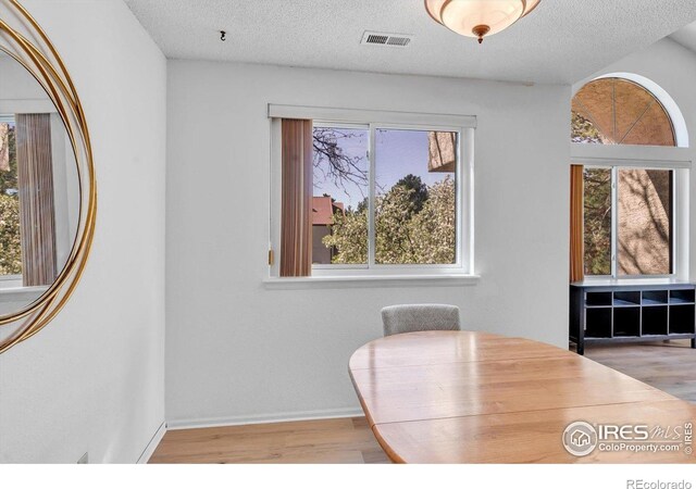 5035 W 73rd Ave, Westminster, CO 80030 - dining space featuring baseboards, visible vents, a textured ceiling, and wood finished floors