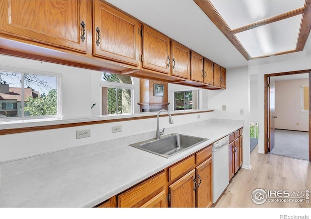 5035 W 73rd Ave, Westminster, CO 80030 - kitchen with dishwasher, light countertops, brown cabinets, and a sink