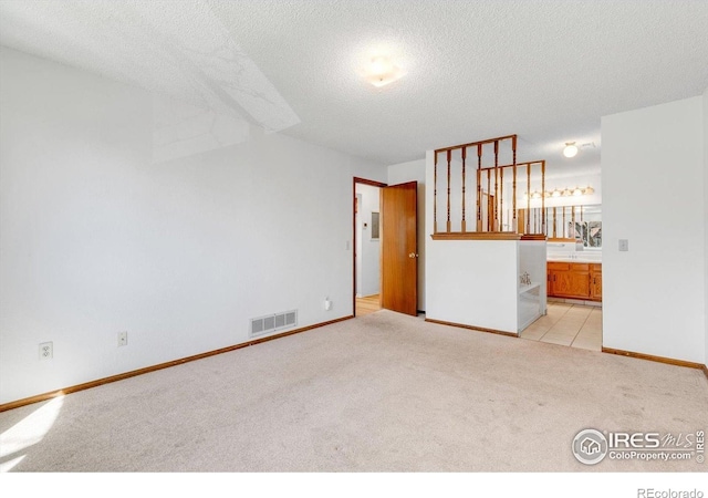 5035 W 73rd Ave, Westminster, CO 80030 - spare room with a textured ceiling, visible vents, baseboards, and light carpet