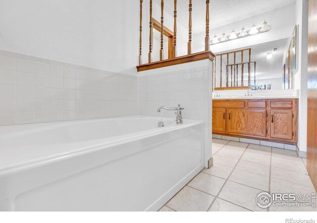 5035 W 73rd Ave, Westminster, CO 80030 - bathroom featuring tile patterned floors, a garden tub, and vanity