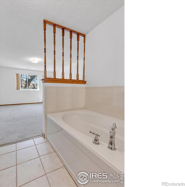 5035 W 73rd Ave, Westminster, CO 80030 - full bathroom with tile patterned flooring, a textured ceiling, and a bath