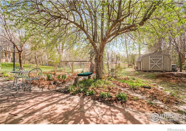 1800 Sumac Ave, Boulder, CO 80304 - view of yard featuring a patio, an outdoor structure, and a storage unit