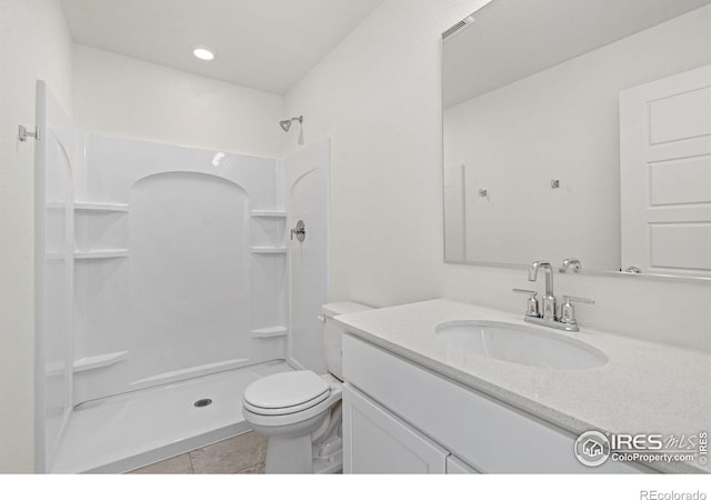 bathroom with toilet, visible vents, tile patterned flooring, walk in shower, and vanity