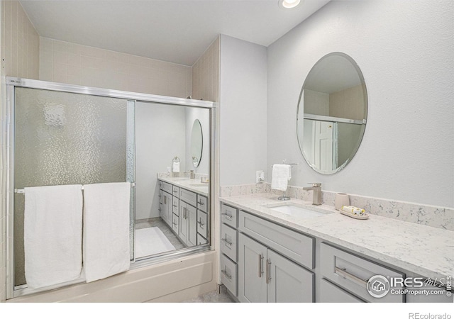 full bath with a shower stall and vanity