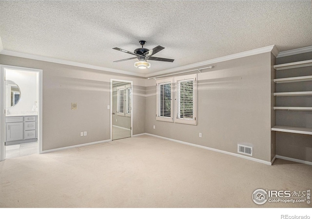 unfurnished bedroom featuring crown molding and carpet
