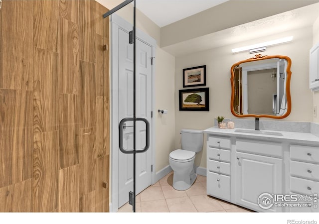 bathroom with tile patterned floors, vanity, and toilet