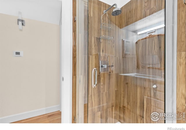 bathroom featuring baseboards and a stall shower