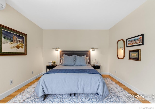 bedroom with baseboards and light wood-style flooring