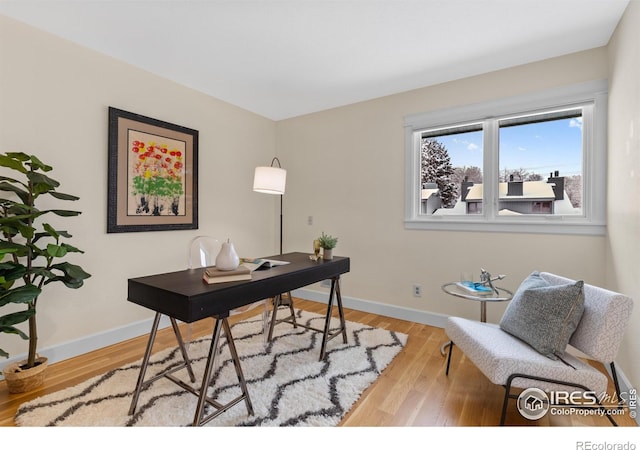 office featuring baseboards and wood finished floors
