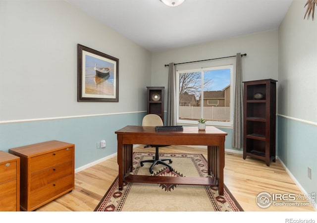 home office with baseboards and light wood finished floors