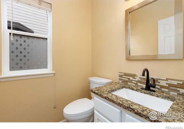 half bath featuring toilet, decorative backsplash, and vanity