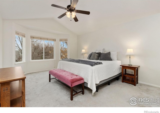 carpeted bedroom featuring baseboards, a ceiling fan, and vaulted ceiling