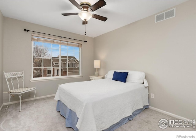 carpeted bedroom featuring a ceiling fan, baseboards, and visible vents
