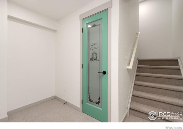 stairs with baseboards and carpet