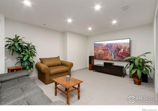 living area with carpet and recessed lighting