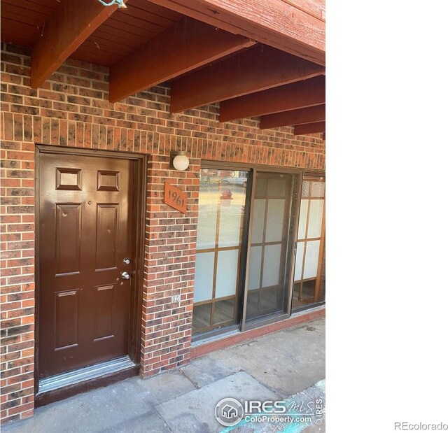1961 Centennial Dr, Louisville, CO 80027 - doorway to property with brick siding