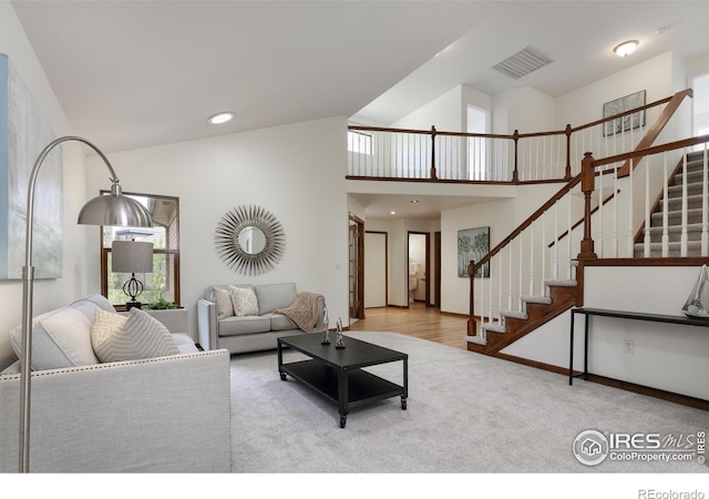 4866 Franklin Dr, Boulder, CO 80301 - living area featuring visible vents, carpet, stairs, and lofted ceiling