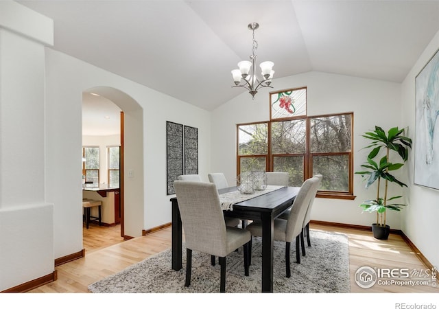 4866 Franklin Dr, Boulder, CO 80301 - dining room featuring light wood-style floors, arched walkways, lofted ceiling, and a notable chandelier