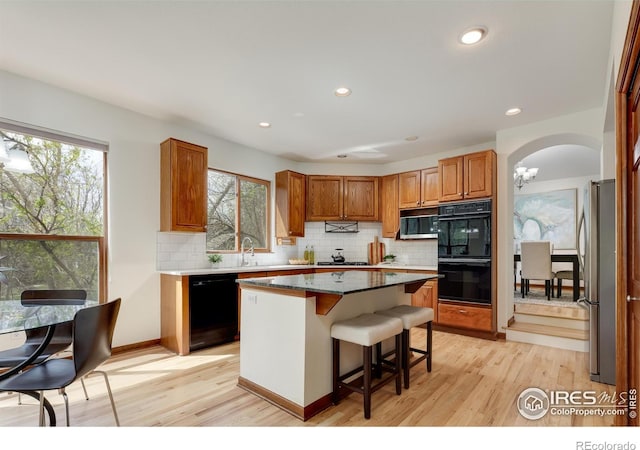 4866 Franklin Dr, Boulder, CO 80301 - kitchen featuring a wealth of natural light, black appliances, and light wood-style floors