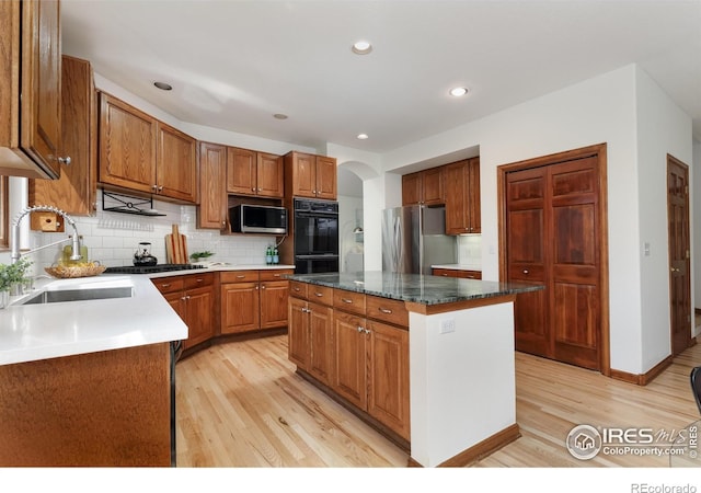 4866 Franklin Dr, Boulder, CO 80301 - kitchen with backsplash, appliances with stainless steel finishes, arched walkways, light wood-type flooring, and a sink