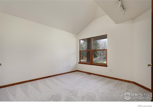 4866 Franklin Dr, Boulder, CO 80301 - spare room with track lighting, baseboards, carpet, and lofted ceiling