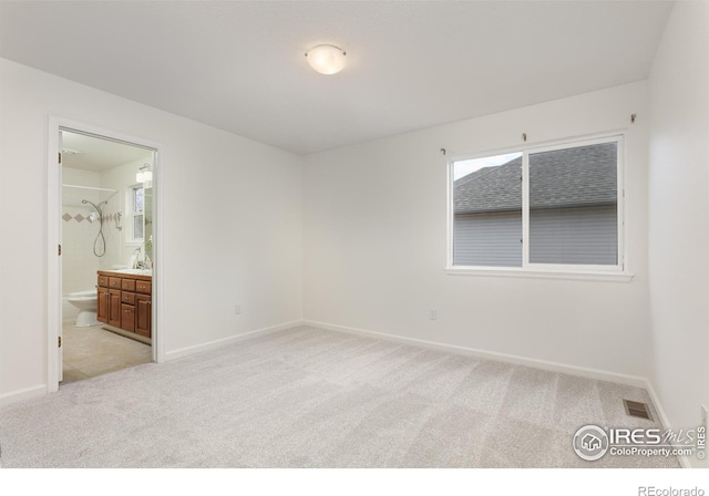 4866 Franklin Dr, Boulder, CO 80301 - unfurnished bedroom with visible vents, baseboards, ensuite bath, and light carpet