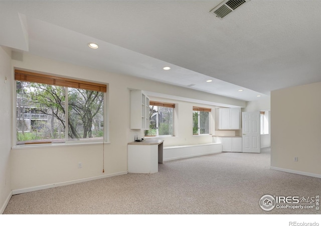 4866 Franklin Dr, Boulder, CO 80301 - unfurnished living room with a healthy amount of sunlight, baseboards, visible vents, and light colored carpet