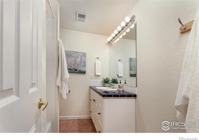 4866 Franklin Dr, Boulder, CO 80301 - full bathroom with visible vents, walk in shower, vanity, baseboards, and tile patterned floors