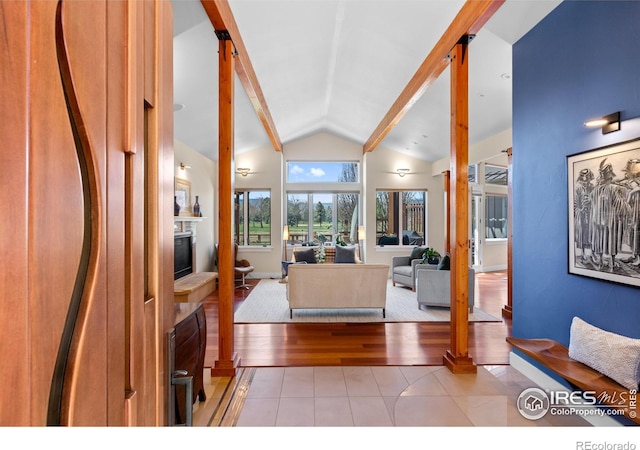 1533 Old Tale Rd, Boulder, CO 80303 - living room with a glass covered fireplace, light tile patterned flooring, and lofted ceiling