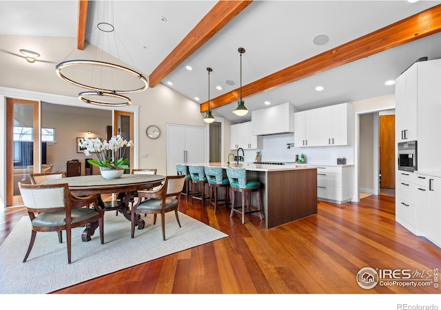 1533 Old Tale Rd, Boulder, CO 80303 - dining room featuring dark wood finished floors, beam ceiling, high vaulted ceiling, an inviting chandelier, and recessed lighting