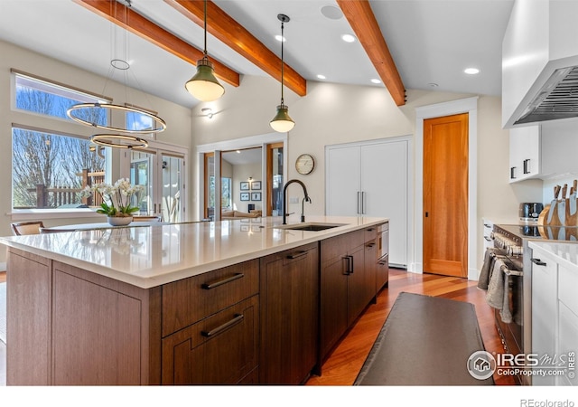 1533 Old Tale Rd, Boulder, CO 80303 - kitchen featuring wood finished floors, high end stainless steel range, light countertops, wall chimney exhaust hood, and a sink