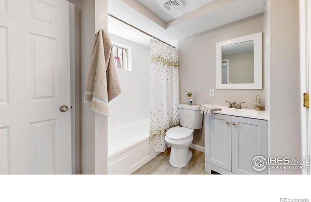 bathroom with vanity, toilet, wood finished floors, and visible vents