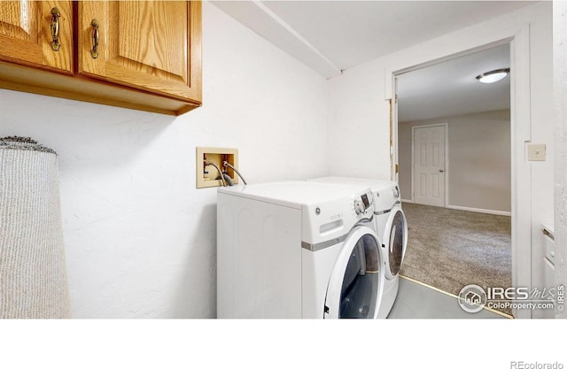 washroom featuring separate washer and dryer, carpet floors, and cabinet space
