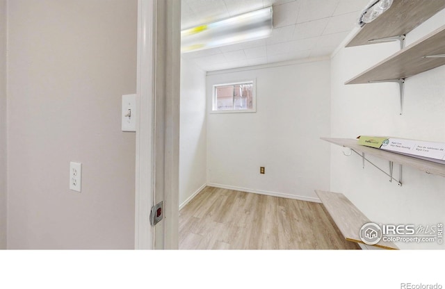 below grade area with light wood-type flooring and baseboards