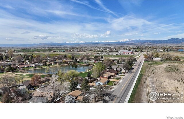birds eye view of property with a water and mountain view