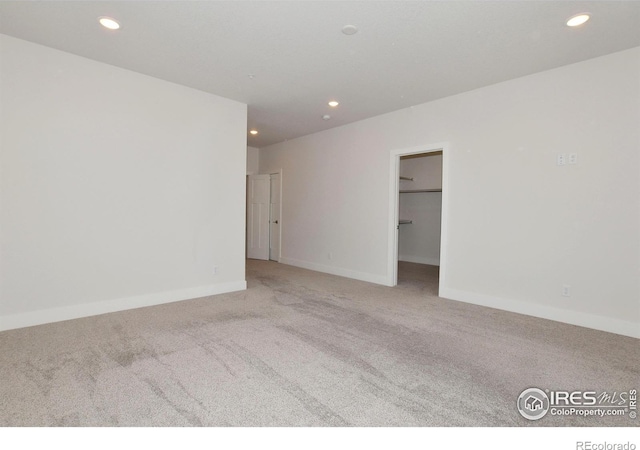 unfurnished room with carpet floors, recessed lighting, and baseboards