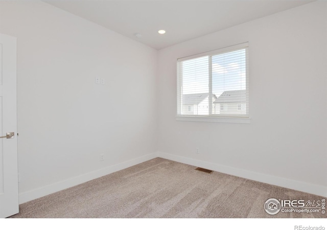 carpeted spare room with baseboards and recessed lighting