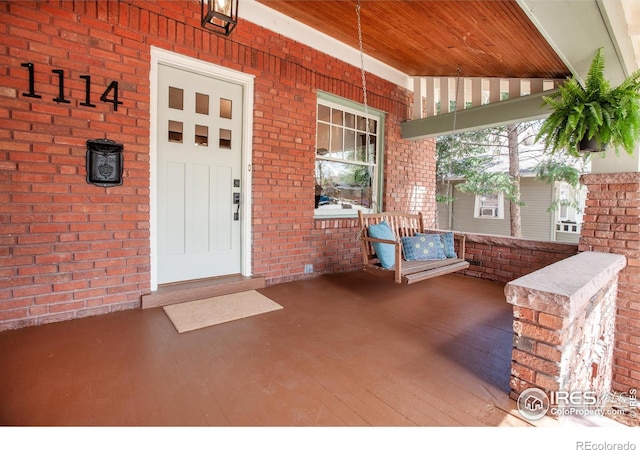 1114 5th Ave, Longmont, CO 80501 - property entrance with a porch and brick siding