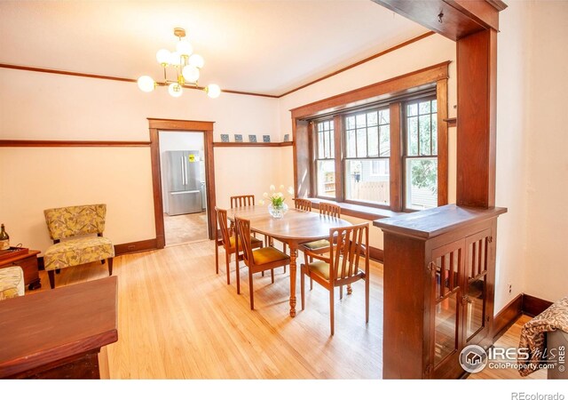 1114 5th Ave, Longmont, CO 80501 - dining area with an inviting chandelier, baseboards, and wood finished floors