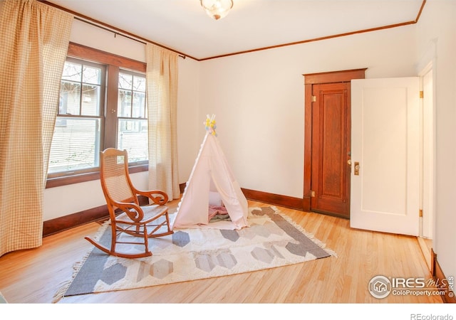 1114 5th Ave, Longmont, CO 80501 - playroom featuring baseboards, ornamental molding, and light wood-type flooring