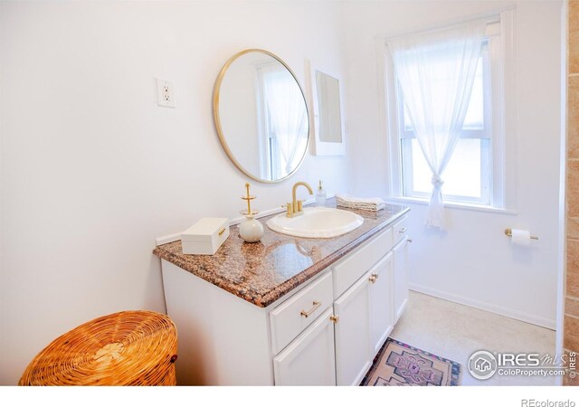 1114 5th Ave, Longmont, CO 80501 - bathroom with baseboards and vanity