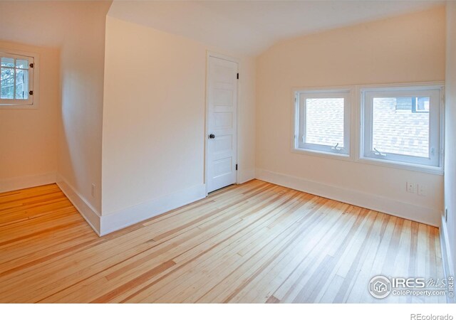 1114 5th Ave, Longmont, CO 80501 - unfurnished room featuring baseboards, wood-type flooring, and lofted ceiling